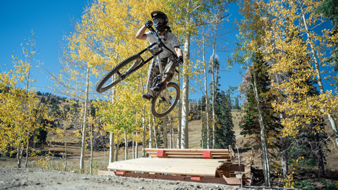 Ryan McElmon rides a wood feature on Unleaded at Solitude Bike Park