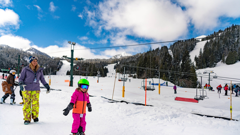 Child with parent skiing
