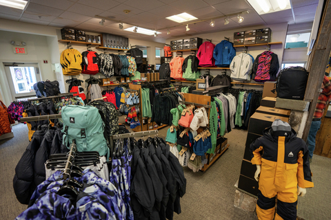 display of jackets, snow pants, snowboarding bags, and snowboard clothes available in the stratton village burton store