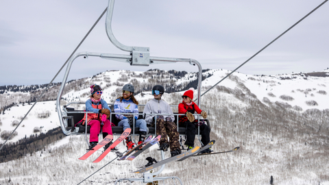 Friends ride Eagle Express while spring ski at Solitude Mountain Resort.