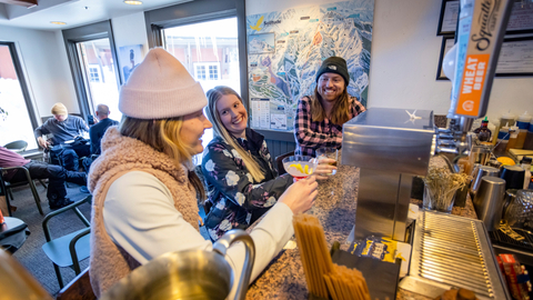 Three friends enjoying après at Honeycomb Grill at Solitude Mountain Resort.