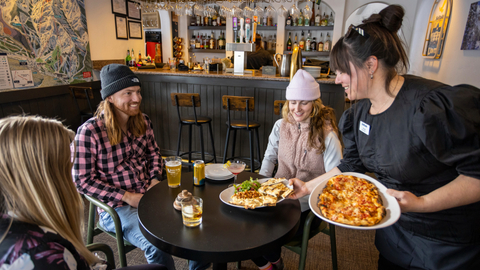 Three friends enjoy après at Honeycomb Grill at Solitude Mountain Resort.