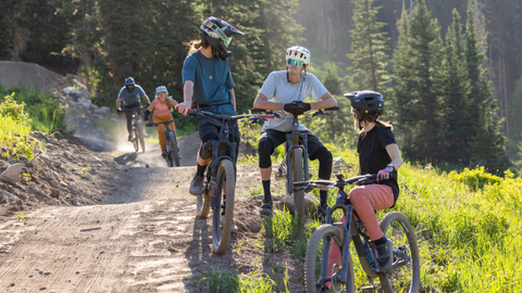 A group of friends ride Cobalt Cruise at Solitude Bike Park.
