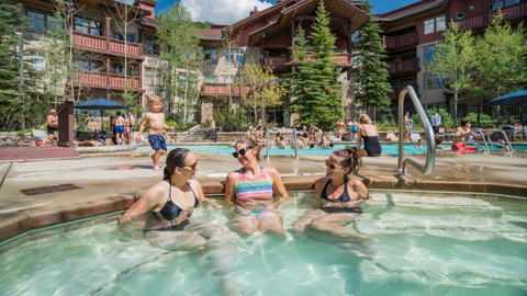 A group of female friends hanging out in the outdoor hot tub of Club Solitude at Solitude Mountain Resort