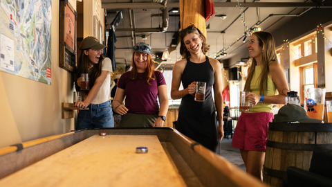People enjoying food, drinks, and games at The Thirsty Squirrel at Solitude Mountain Resort