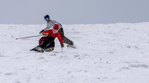 Two friends spring ski and snowboard at Solitude Mountain Resort.