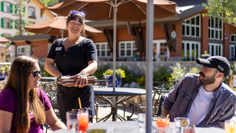 Two friends enjoy lunch on the Honeycomb Grill patio.