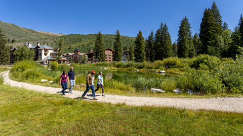 A group of friends walk around the pond while staying in Solitude Village. 