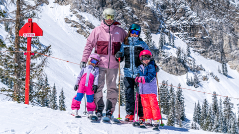 A family stops for photo in front of Honeycomb Canyon at Solitude Mountain Resort.
