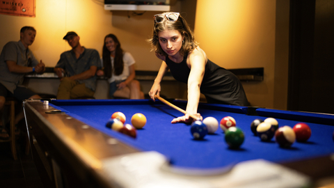 Friends enjoying food, drinks, and pool at The Thirsty Squirrel at Solitude Mountain Resort