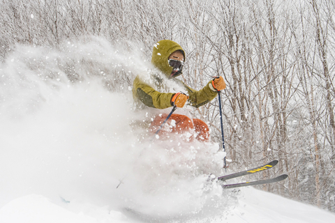Skier going through powder at Stratton Mountain